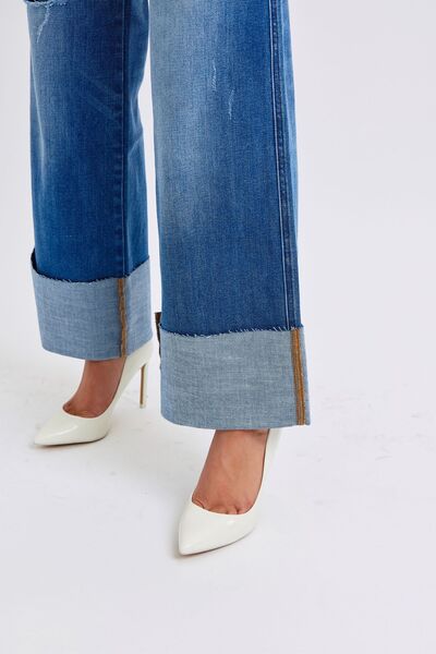 Detailed close-up of the hem of Judy Blue High-Waist Wide-Leg Jeans, designed with a modern, frayed edge for a laid-back vibe.